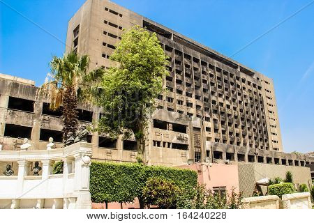 CAIRO EGYPT-MAY 4 2015. The building used by the National Democratic Party of the ousted president Mubarak remains burnt and abandoned serving as a reminder of the 2011 Egypt Revolution Cairo.