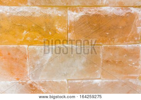 Brick background abstract weathered texture of stained old light brown stucco and painted red yellow brick wall background in rural room Grungy rusty blocks of stonework tech dark retro color architecture . Orange stone