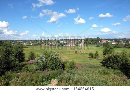 Beautiful countryside rural landscape with homes on hills far away on hot sunny summer day