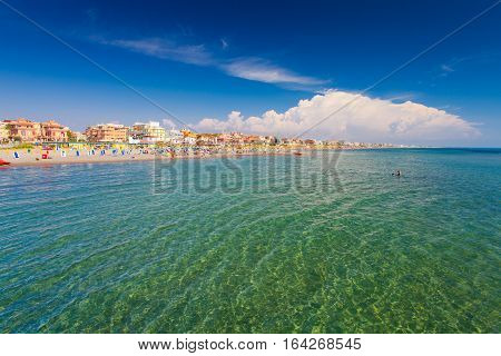 Lido di Ostia, ITALY - September 14 2016: Swimming and relaxing people on the beautiful beach Lido di Ostia ( Lido di Roma) private beach Battistini Italy.