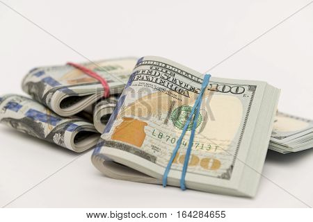 Packs of hundred dollar banknotes with rubber bands