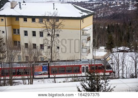 SLOVAKIA HORNY SMOKOVEC - JANUARY 05 2015: High speed electric train moves through the Horny Smokovec. Is a ski village located in the mountains of the High Tatras at an altitude of 950 m a.s.l.