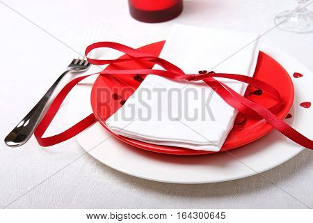 Red and white table setting for diner anniversary celebration on Valentine's Day