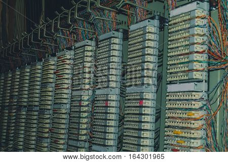 telephone patch panel in datacenter server room, a plurality of cables, cross bar