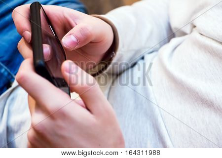 Young Man using a smartphone for texting and communication