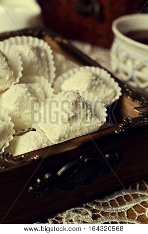 Sweets with white chocolate and coconut chips. Selective focus.