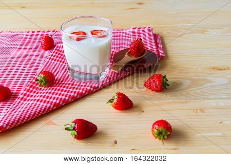 strawberry in yogurt with Put on a red table cloth background heart in yogurt with valentine 's day.