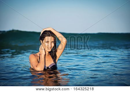 Beautiful girl is posing in the sea