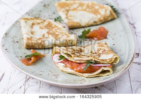 cheese pancakes with salmon sour cream and herbs