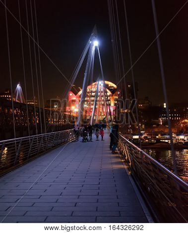 London, UK. 5th January 2017. The Hungerford footbridge with Charing Cross railway station to the side and the River Thames running underneath it. The weather is cold.