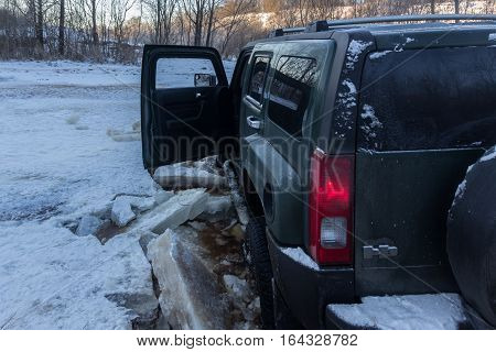 The river Tosno, Leningrad oblast, Russia - January 01, 2017, H3 Hammer on the shore of the river, the Hummer H3 is a compact SUV produced by GM