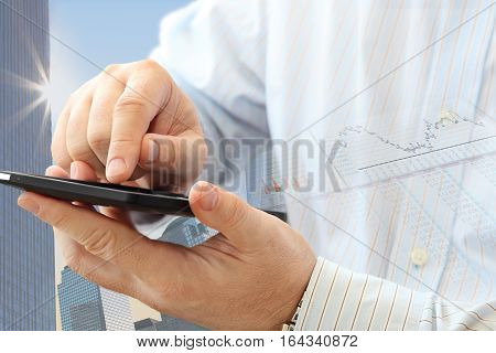 Close up of man using smartphone on urban background