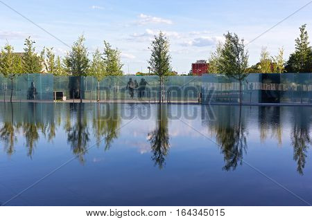 WASHINGTON DC USA - AUGUST 7: American Veterans Disabled for Life Memorial dedicated to wounded in combat on August 7 2016 in Washington DC. Reflection pool and young trees create a calming effect.