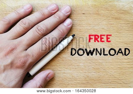 Human hand over wooden background and free download text concept