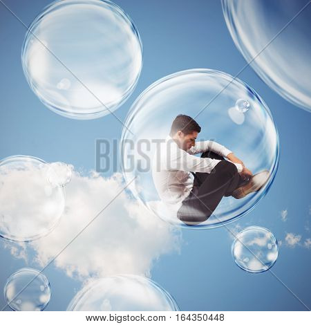 Sad businessman flies in a bubble. isolate themselves inside a bubble detachment from the outside world concept