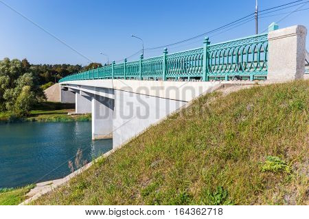 White concrete bridge with forged green fencing