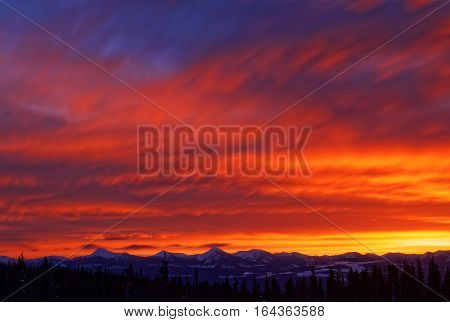 Vibrant Sunrise over Snowcapped Canadian Mountain Range