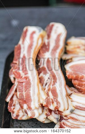 Sliced fresh beacon in the streed marked