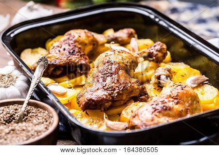 Roasted chicken leg with potatoes with caraway and garlic.