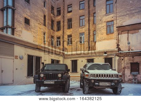 Saint Petersburg , Russia - January 08, 2017, Hammer H3 and Jeep Wrangler Jk in the courts of St. Petersburg, the Hummer H3 is a compact SUV produced by GM