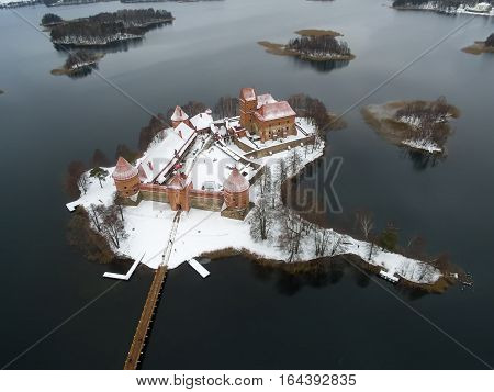 Trakai, Lithuania: aerial winter UAV top view, flat lay of gothic Island Castle. Historical residence in capital city of Grand Duchy of Lithuania, located in Galve lake