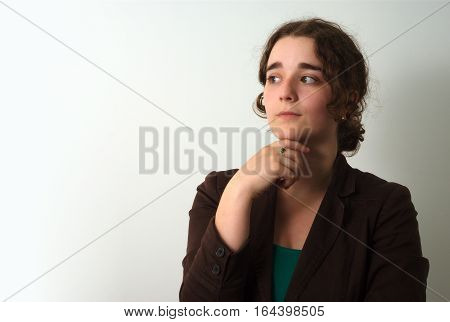 young thoughtful woman pensive wondering looking left studio shot