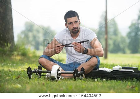 Man Tightening Drone Propeller In Nature
