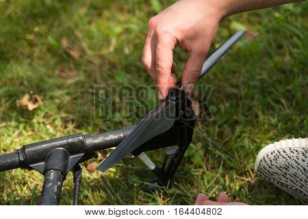 Man Tightening Propeller On Drone In Nature