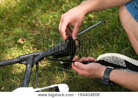 Man Tightening Drone Propeller In Nature