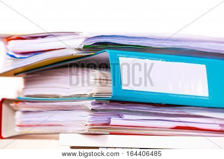 Paperwork. Stack of file folders ring binders on office table dask.
