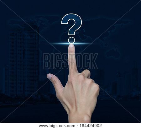 Hand pressing question mark sign icon over world map and city tower Customer support concept Elements of this image furnished by NASA