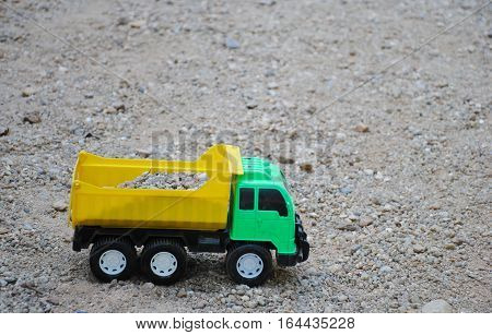 Children's toy truck car on playground, industrail symbols