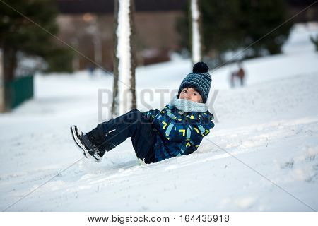 Cute Child, Boy, Sliding With Bob In The Snow, Wintertime