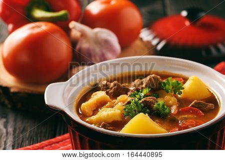 Hungarian soup goulash (bograch) with dumplings .