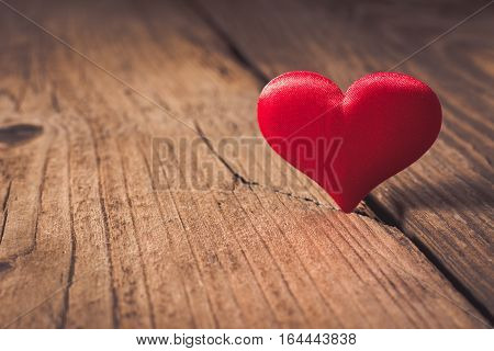 Valentines day. Red heart on wooden background. Copy space