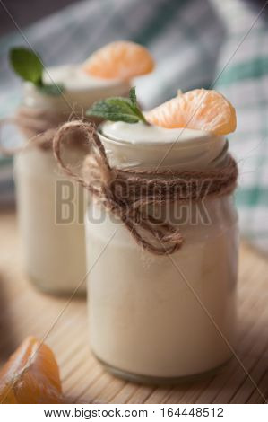Fresh Organig Natural White Yogurt In Glass Jars With Tangerine And Mint