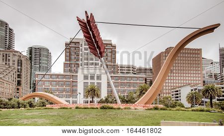 San Francisco, CA, USA - August 3, 2014: A sculpture resembling Cupid's bow and arrow is wedged in the ground alongside the Bay Bridge of San Francisco's Embarcadero