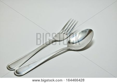 Stainless steel utensils on a white background.