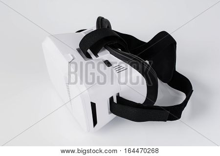 Virtual reality VR glasses or goggles isolated on white background with mirror reflection. Closeup product photograph. Computer simulated reality concept image with copy space 3D