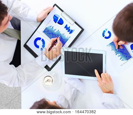 Close-up of business team hands over papers during discussion of a new project