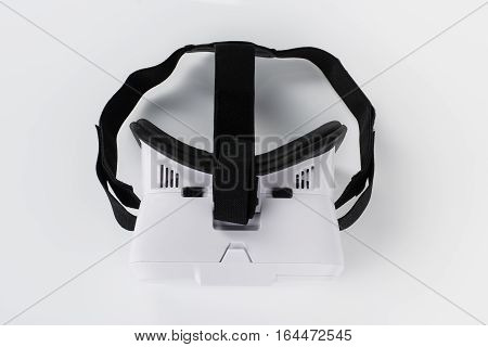 Virtual reality VR glasses or goggles isolated on white background with mirror reflection. Closeup product photograph. Computer simulated reality concept image with copy space 3D