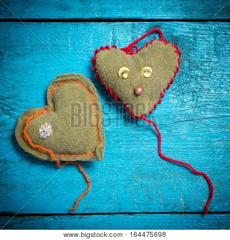 Valentine's Day. Colorful knitted hearts. Red heart on the blue boards. Valentines day. Heart pendant. Red heart. Valentine cards. Space for text. Eighth of March. International Women's Day.