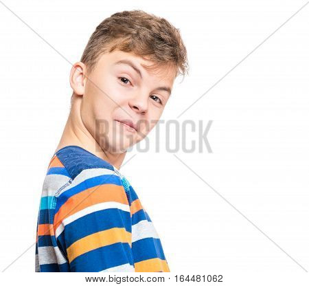Teen boy making silly grimace - funny surprised face. Playful child isolated on white background. Emotional portrait of caucasian teenager looking at camera.