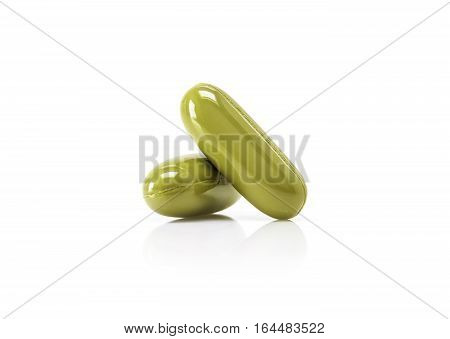 green herbal supplement capsule foe health care isolated on white background