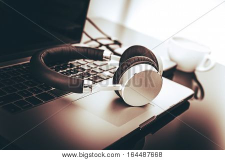 Modern Mobile Computer Station. Modern Laptop and Wireless Headphones. Freelance Workstation.