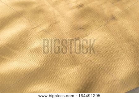 Gold texture with kinks and scratches abstract background. Golden background