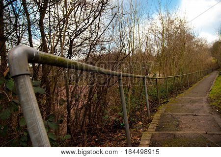 Path with steel handrail, nicely curved towards horizon