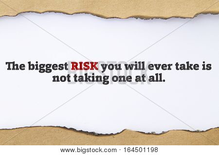 The biggest risk you will ever take is not taking one at all message written under torn paper.