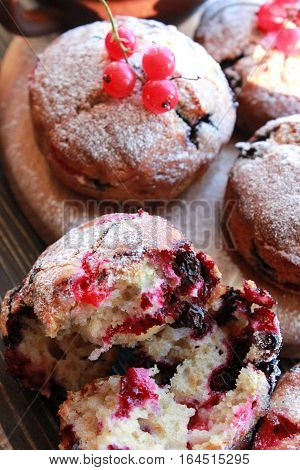 Homemade berry Muffins with fresh berries on wooden table