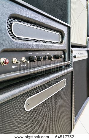 Musical equipment. Several speakers with a control unit with toggle switches and adjusting knobs